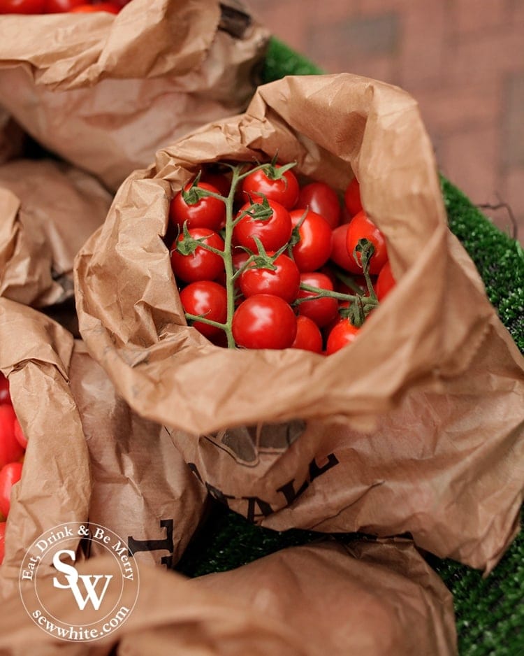 A brown paper over flowing with vine ripened tomatoes at Wimbledon Village Farmers' Market.