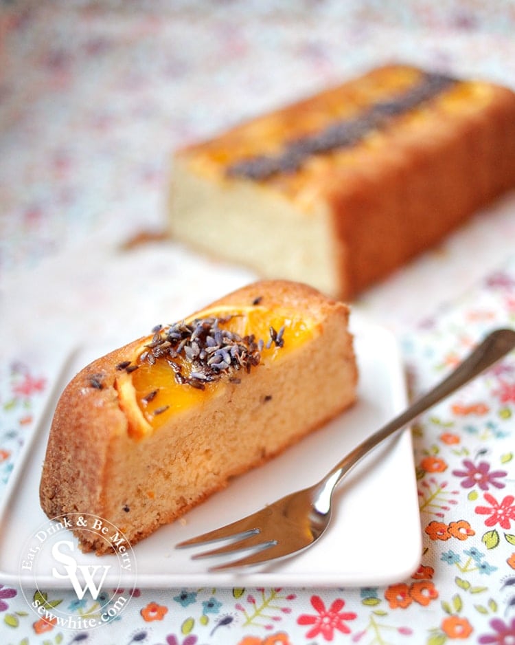 The first slice of the Orange Lavender Loaf. Topped with orange slices and edible dried lavender.