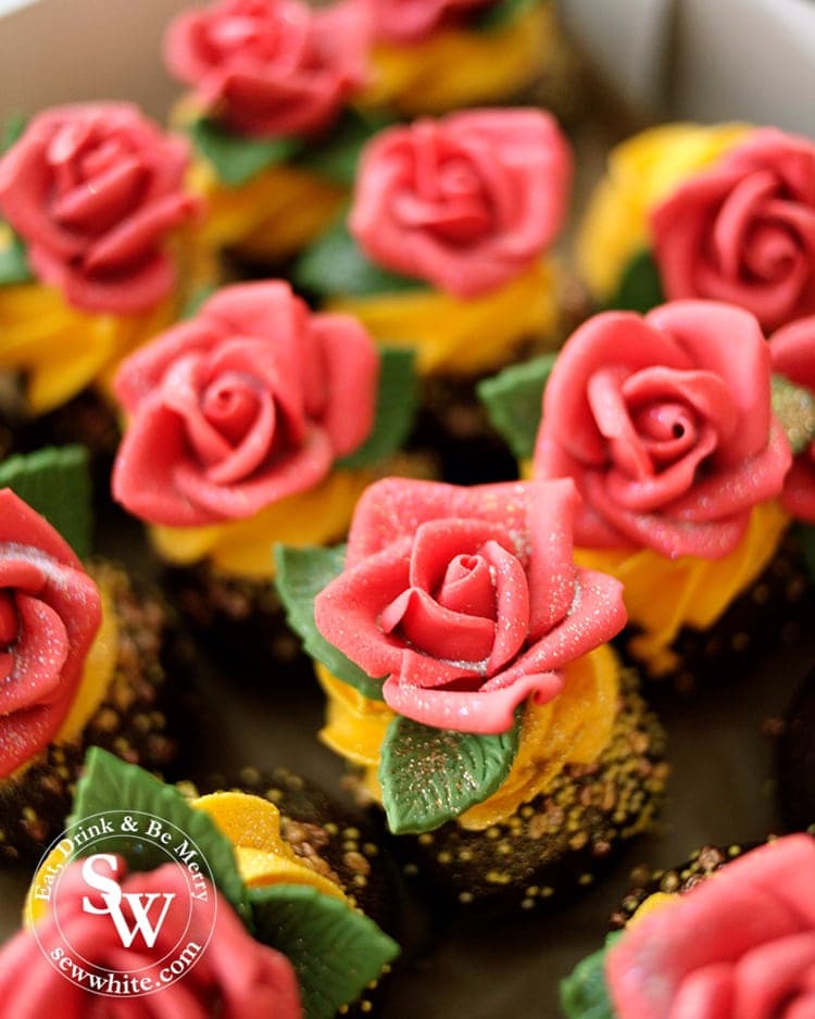 The most perfect cakes for the Beauty and the Beast Party. Chocolate cake pops topped with edible red roses on yellow buttercream.