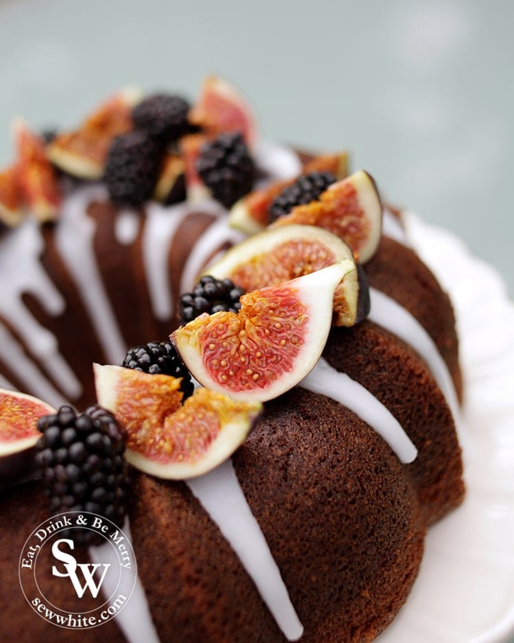 Close up of the Autumn bundt Cake. Red figs and blackberries in the autumn light. 