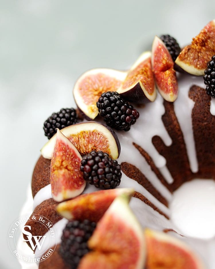 Close up of the fresh figs and blackberries on top of the white drizzle icing on the Blackberry and Ginger bundt Cake.