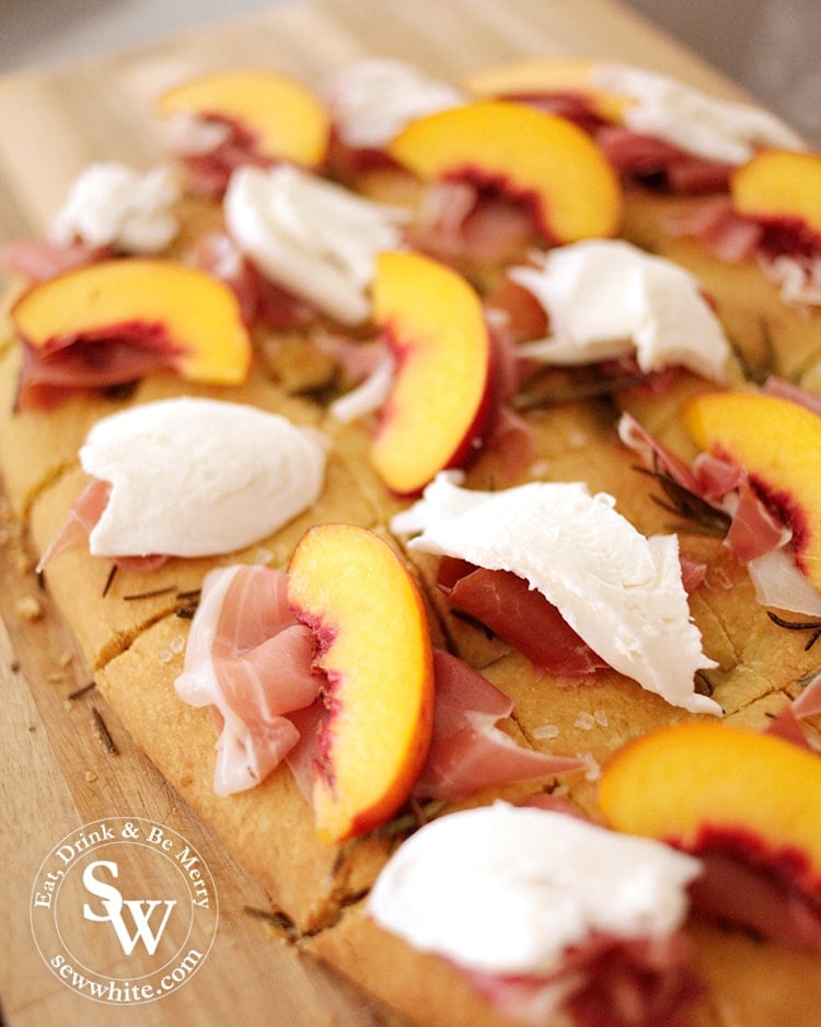 A close up of the peach and parma ham on the focaccia sharing bread.