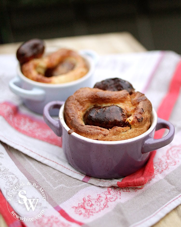 Le creuset mini casseroles in pastel colours filled with my Easy Toad in the Hole. Golden brown batter and dark roasted sausages.