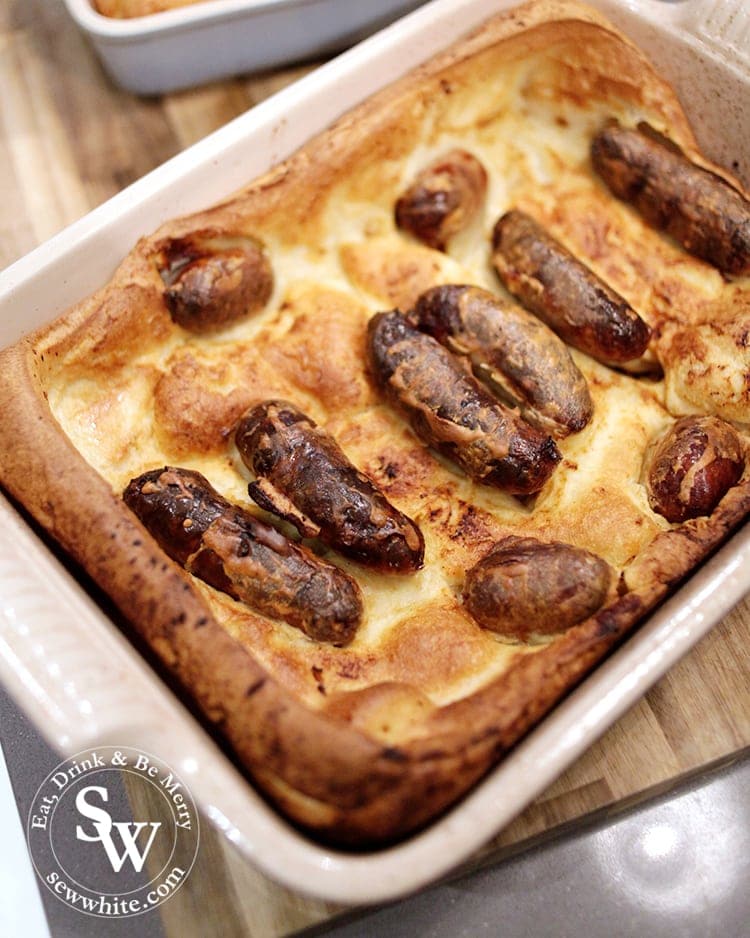 Sausages coated in golden batter in the Easy Toad in the Hole recipe. 