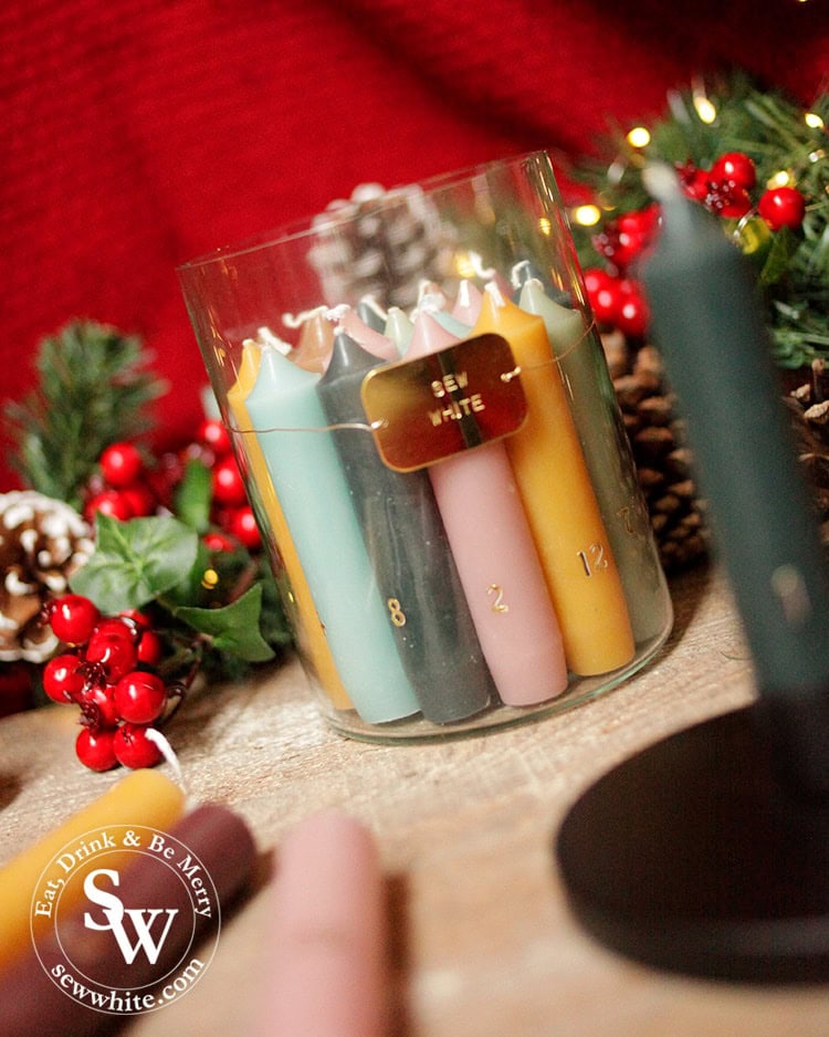 personalised advent candle set from forest and co with sew white written on.