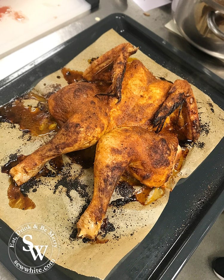 Spatchcock chicken covered in herbs and spices. Meat and poultry day at Cookery School at Little Portland Street.