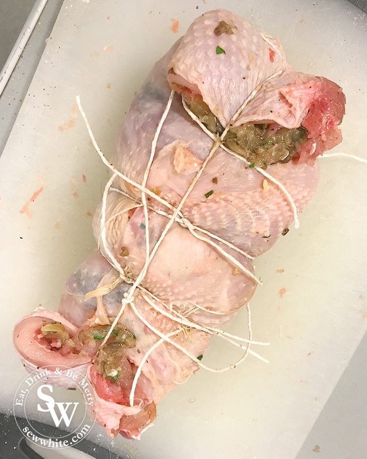 a finished deboned chicken ready to cook wrapped up in string