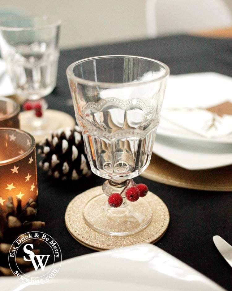 Adding a little bit of colour to the glasses with fake berries on the Christmas table.