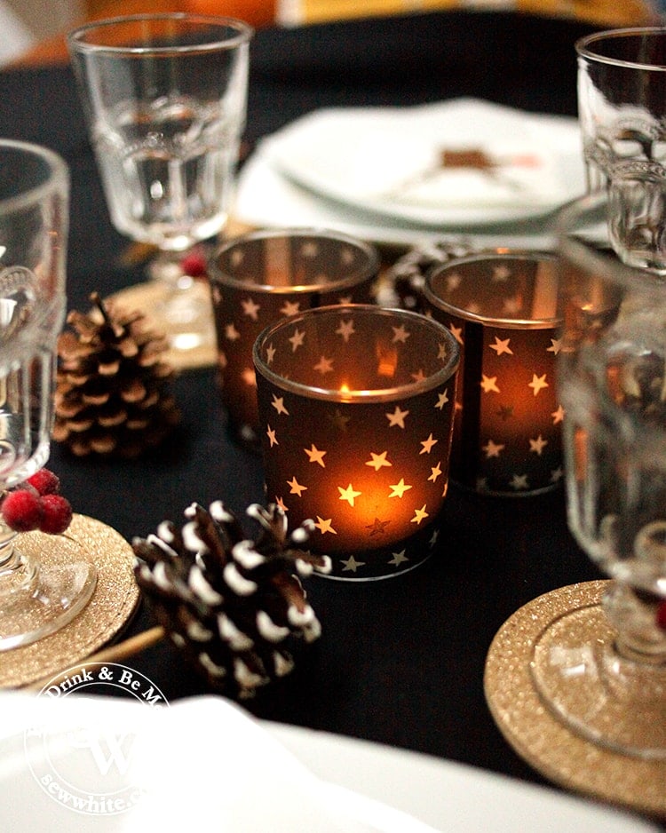 Glowing christmas star candles on the Black Gold and Red Christmas Table