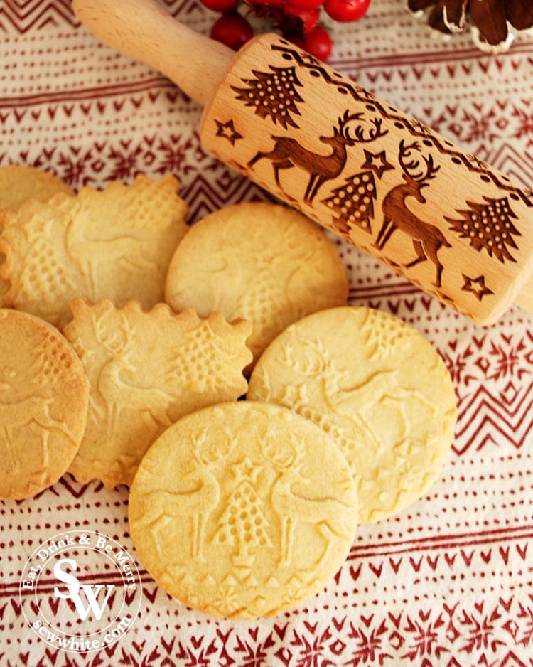 Embossed biscuits fresh out of the oven with reindeer and Christmas trees on