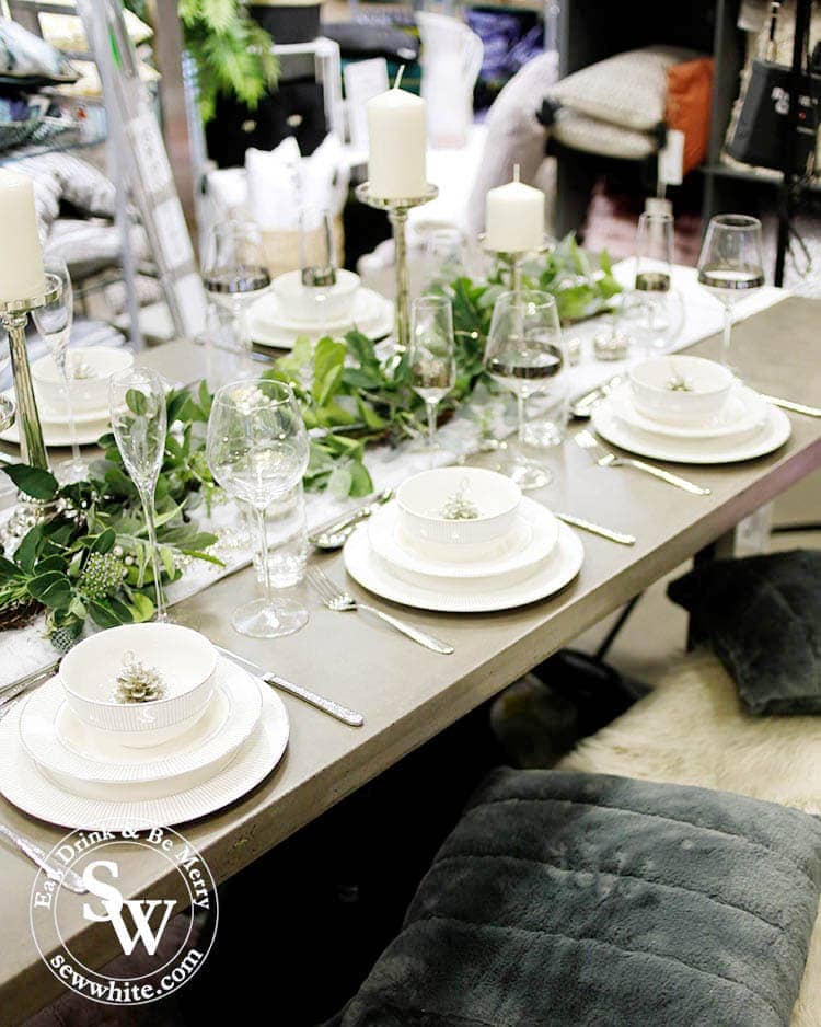 A gorgeous silver, white and green table setting for Christmas 2019 and Elys Wimbledon. Fur blankets and cushions used for seating.