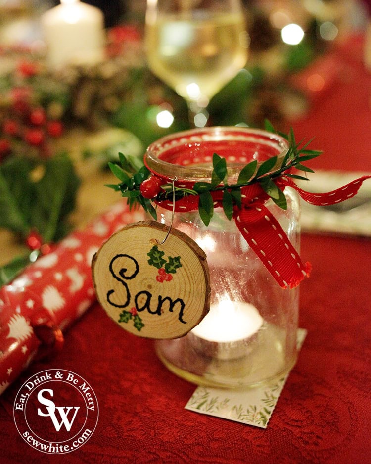 slice of branch with personalised name drawn on place setting. 