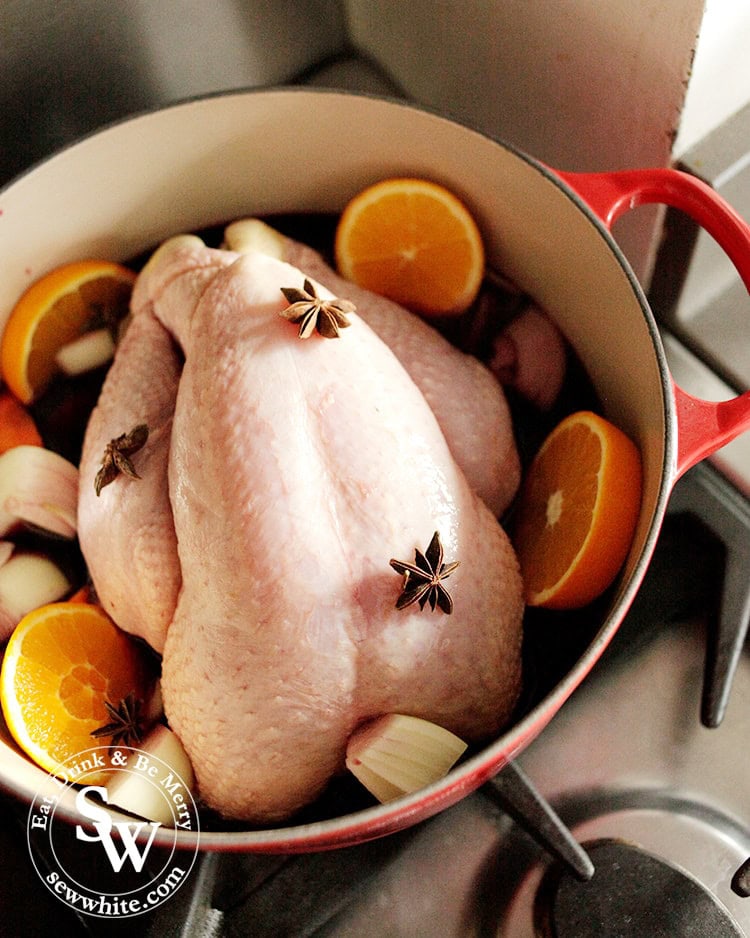 Christmas one pot chicken cooked with red wine and oranges in the Le Creuset Signature Cast Iron Round Casserole ready for the oven decorated with oranges, onions and star anise.