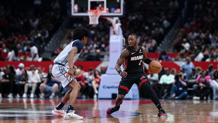 Basketball game with players in action.  Sports