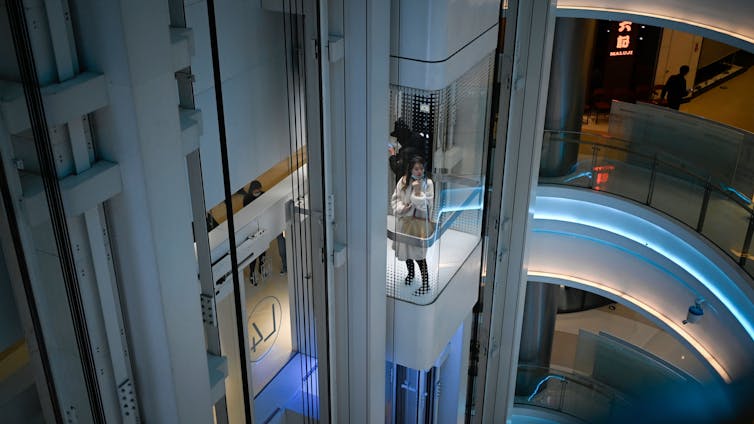 Elevator with people in modern building.