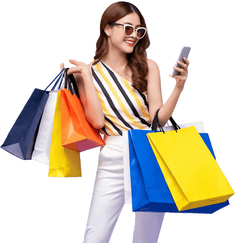 Happy woman carrying colorful shopping bags after fashion retail shopping