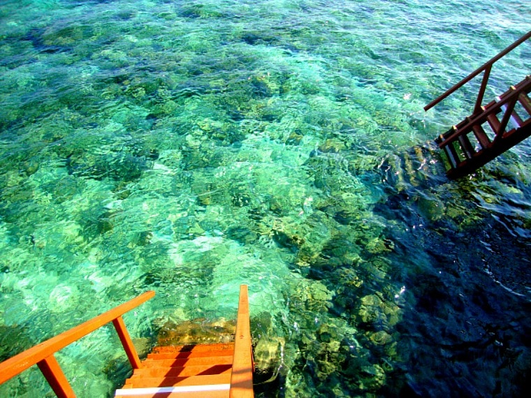 Many Maldives overwater villas feature easy access to the water below.