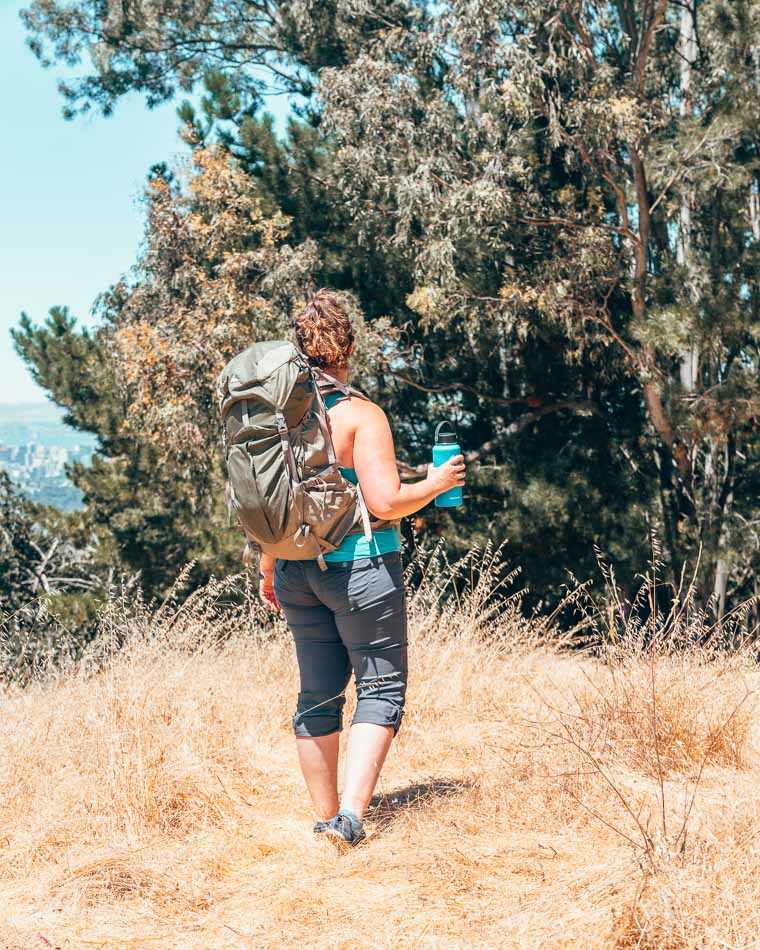 Lia in the prAna Halle pant hiking and wearing a backpack.