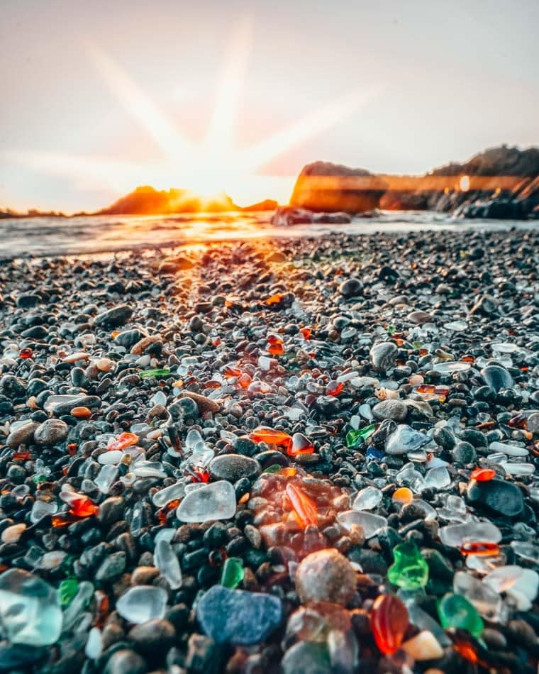 Colorful sand on Glass Beach at sunset in Fort Bragg, California.
