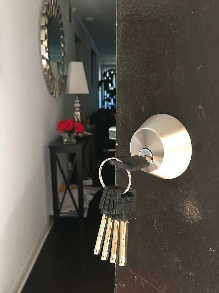 Satin chrome residential deadbolt rekeyed with five newly cut brass keys