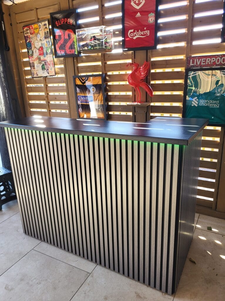 A Liverpool-themed acoustic collection home bar installed in an outdoor garden room