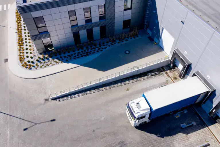 Aerial view of a truck at a building loading dock, representing the importance of reserving dock space for Denver high-rise moves.