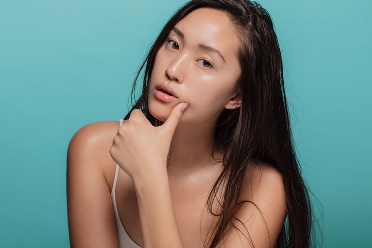 A women touching her face