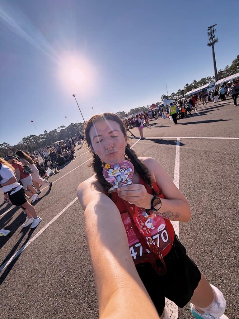 Runner taking a selfie at the Walt Disney World Marathon finish line.