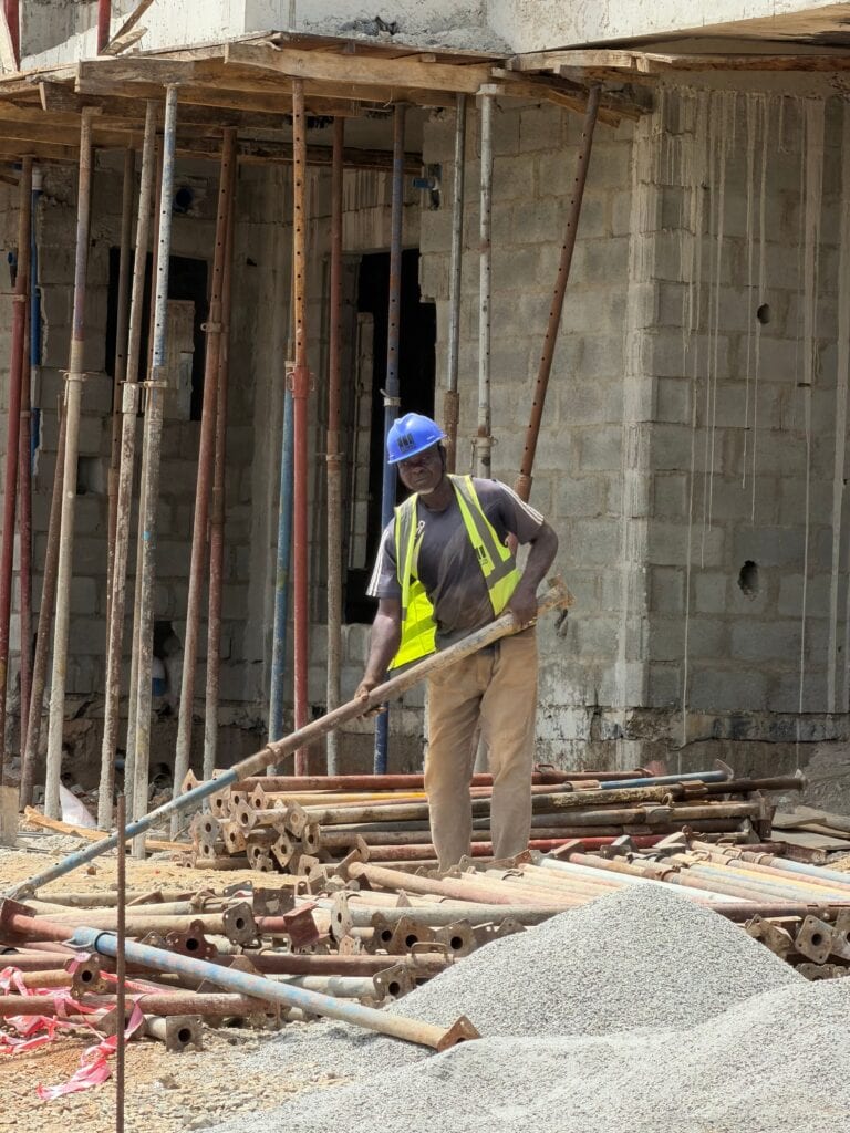 Construction worker operating at a building site, showcasing industry and development.