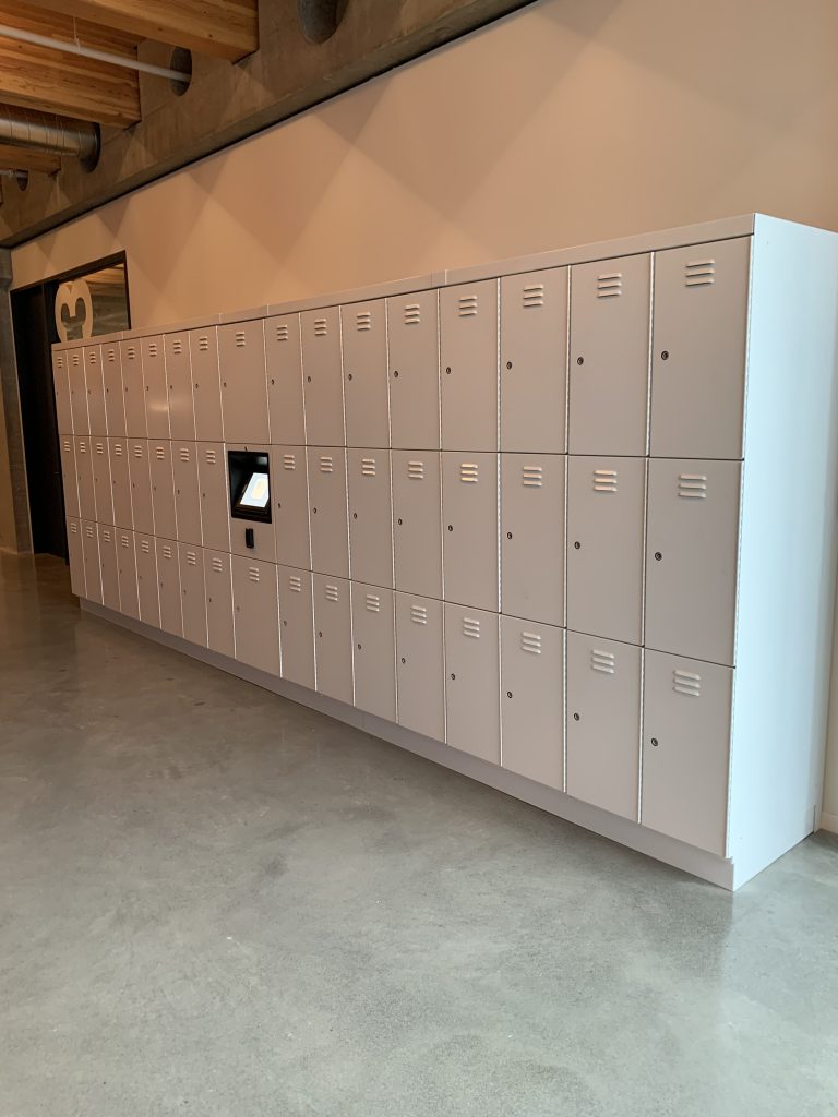 white access control lockers in hallway