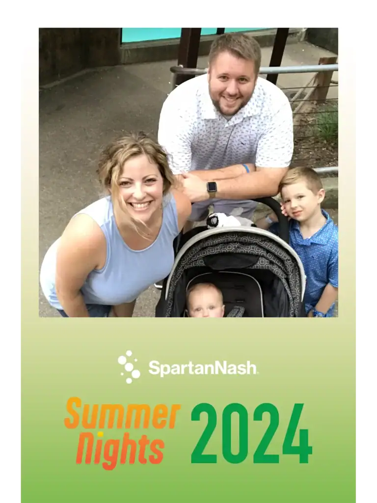 Guests laugh and strike poses in Fastbooth’s photobooth at a Grand Rapids MI celebration, with playful props and lively energy.