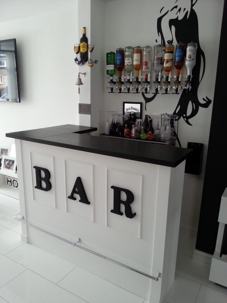 A white home bar with the letters BAR across the front