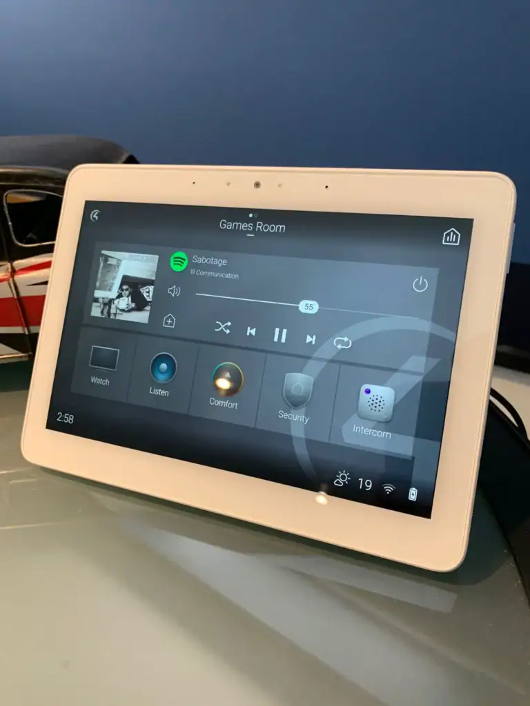 Control4 touchscreen showing music playback for the games room