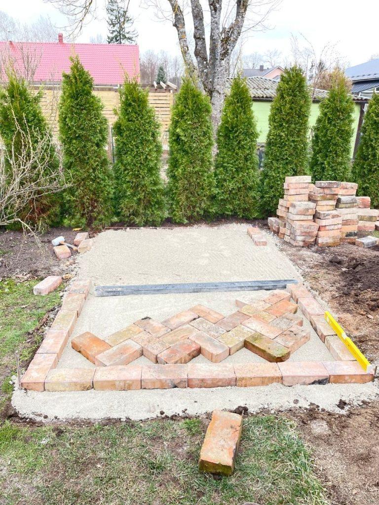 laying red brick paving