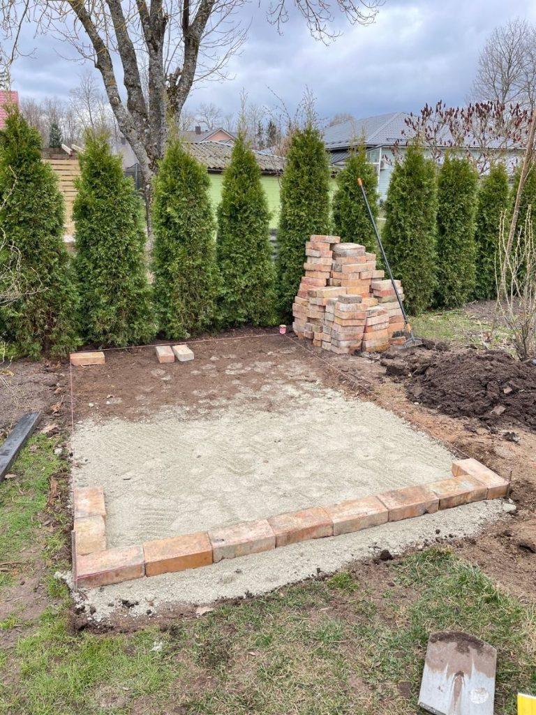 laying red brick paving
