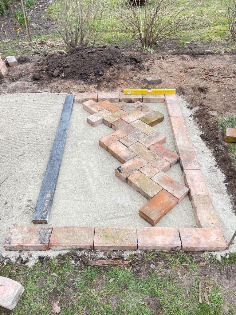 laying red brick paving