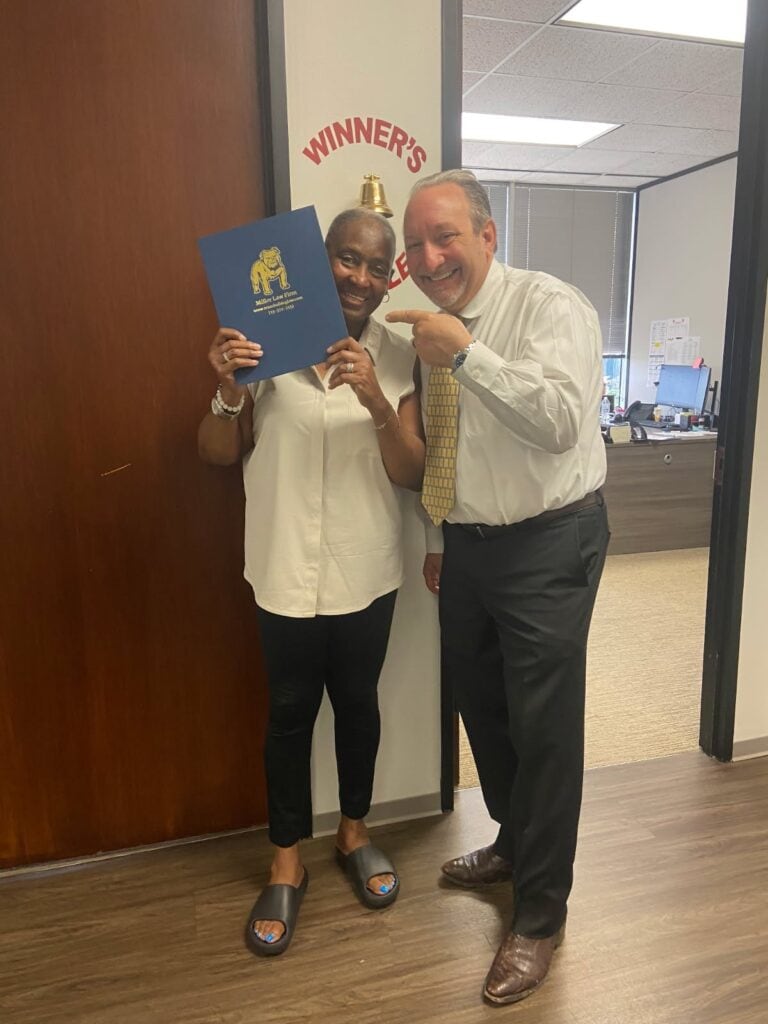 Houston injury client celebrates final settlement at The Texas Bulldog’s office.