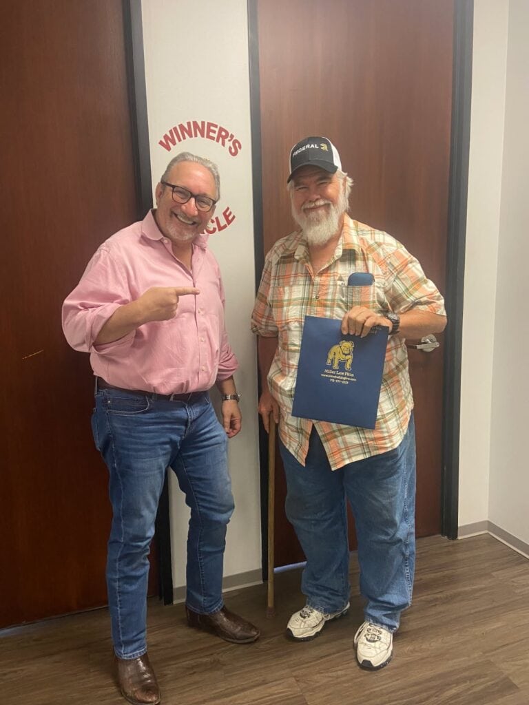 Client ringing winners circle bell at Houston personal injury law firm