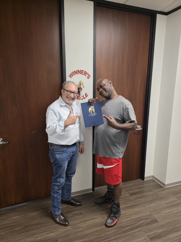 Car accident client celebrating case win in Houston law office