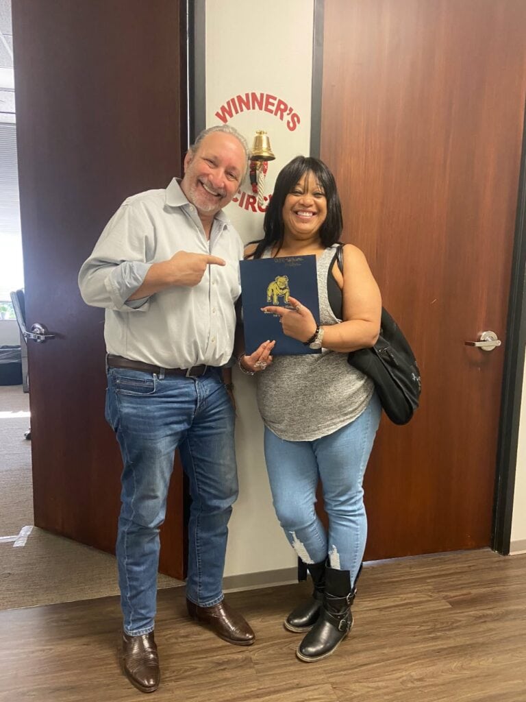 Client celebrating injury case result with The Texas Bulldog