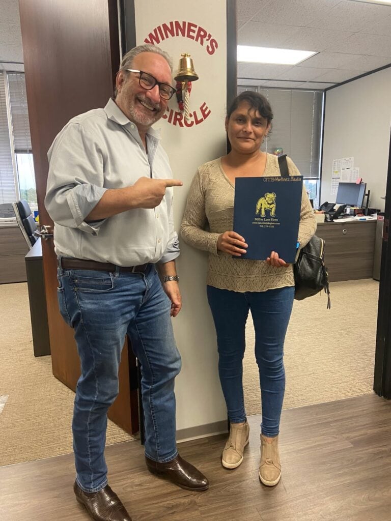 Houston car accident client ringing winners circle bell