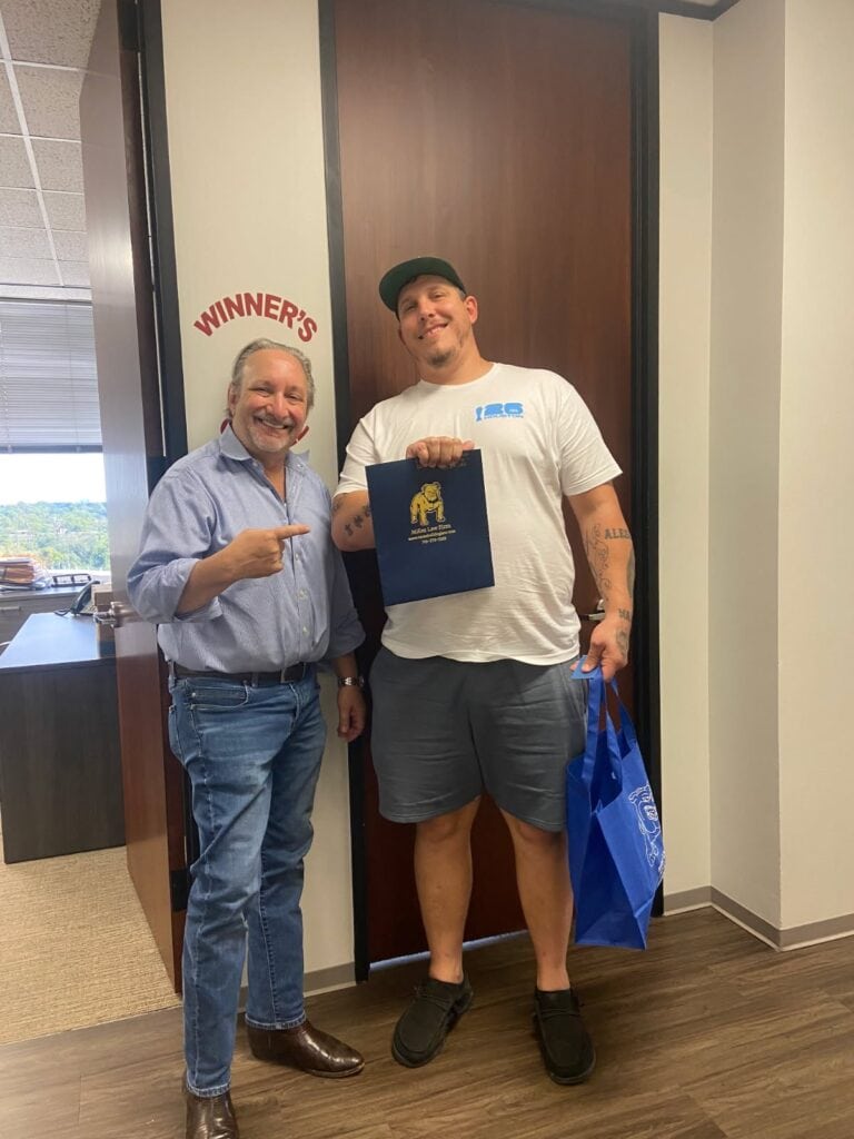 Client ringing bell after Houston auto accident case win