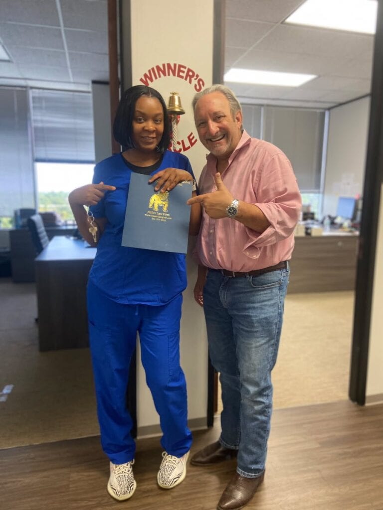 Client celebrating car accident settlement at Houston law firm