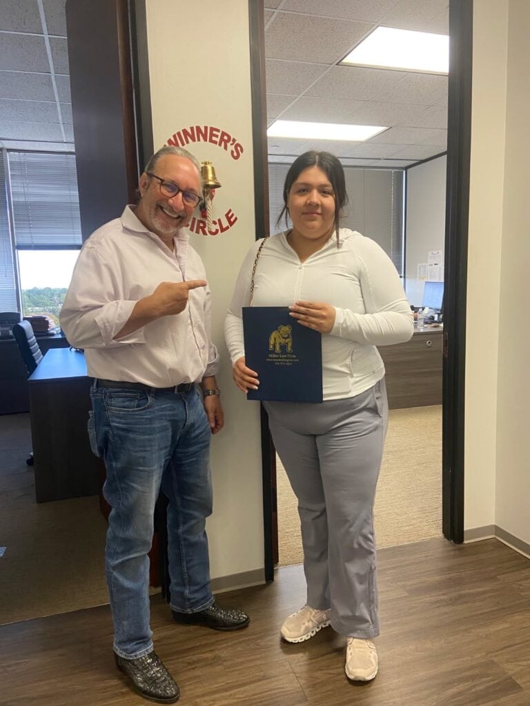 Houston auto accident client ringing winners circle bell