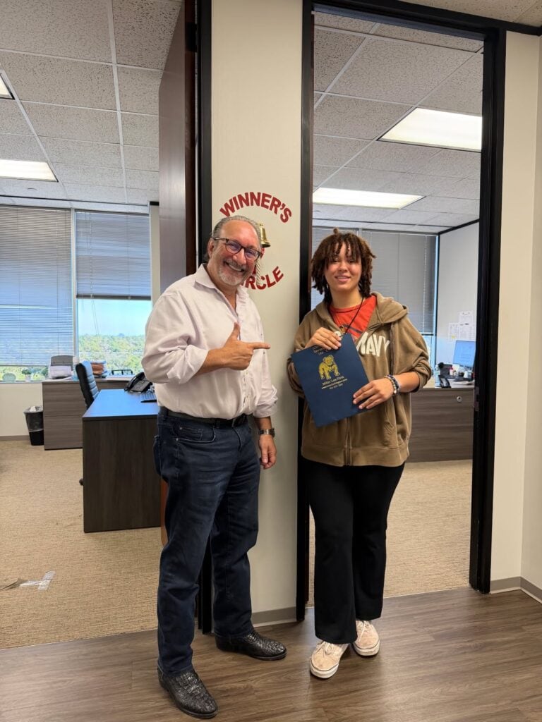 Client ringing bell at The Miller Law Firm Houston office