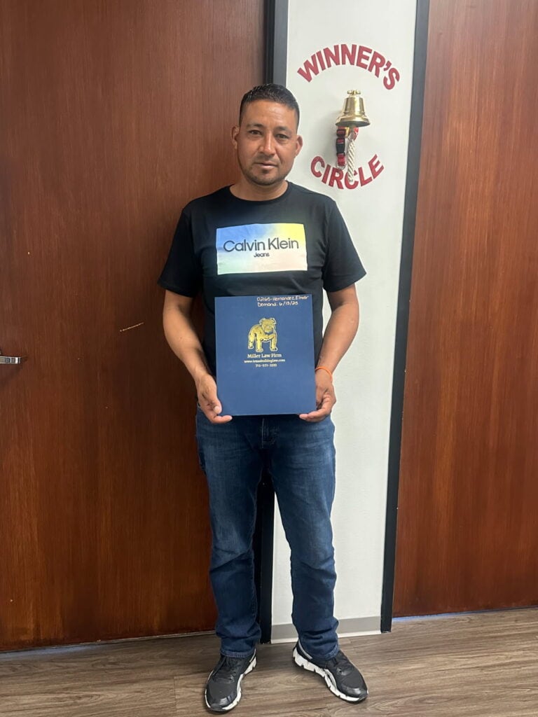 Personal injury client with Adam Miller after case success