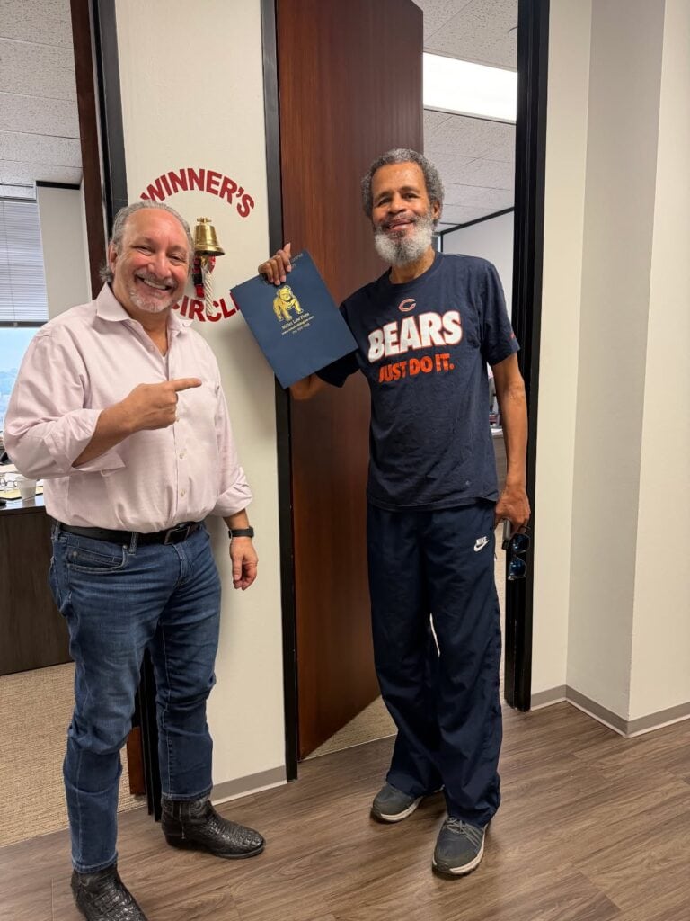 Personal injury client celebrating win with experienced attorney