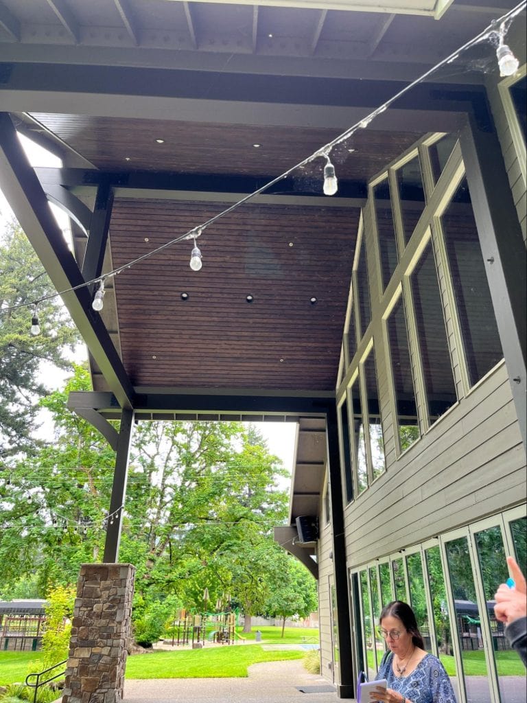 The covered back patio of the main hall. The covering is a permanent roof extended from the main structure, and has embedded lighting.