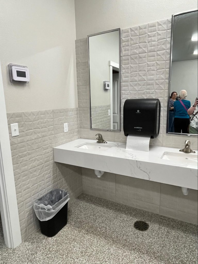 Two sinks in the cabin bathroom. There are mirrors above the sinks and counter space for laying out items around the sinks.