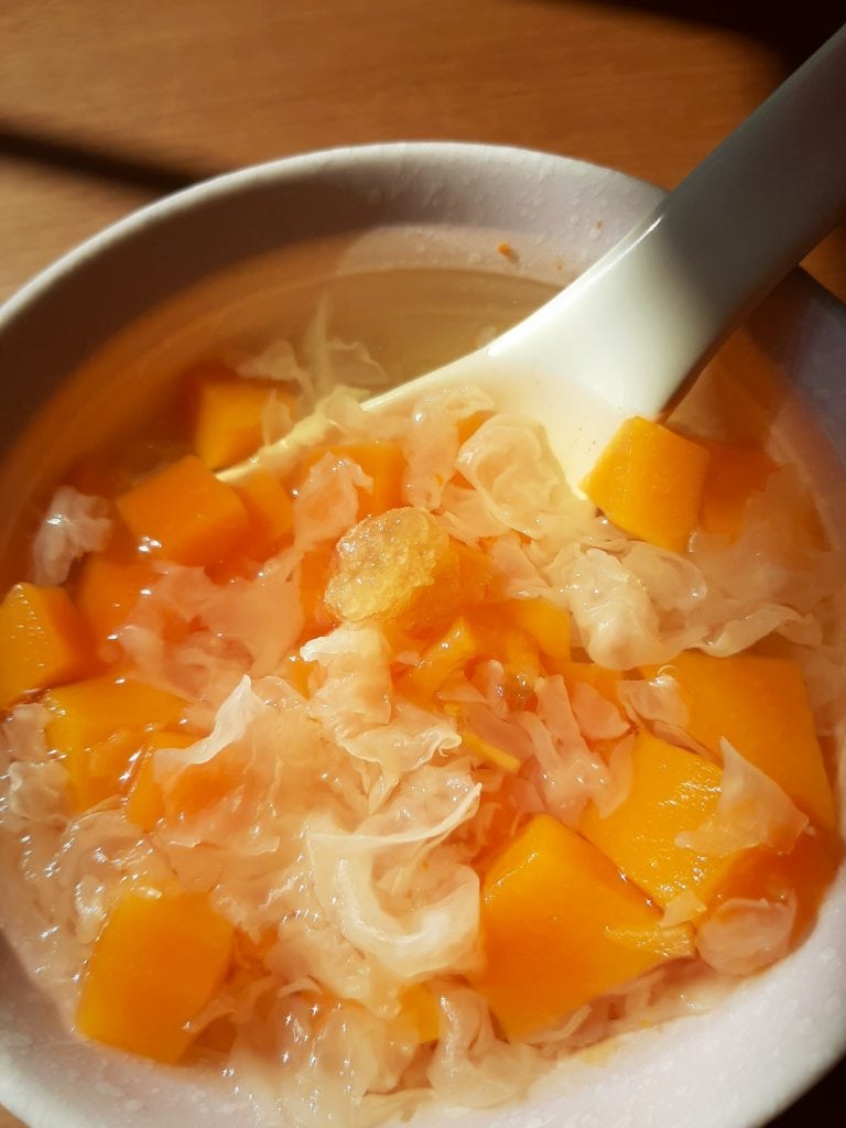 Papaya snow fungus sweet soup in a bowl with a spoon